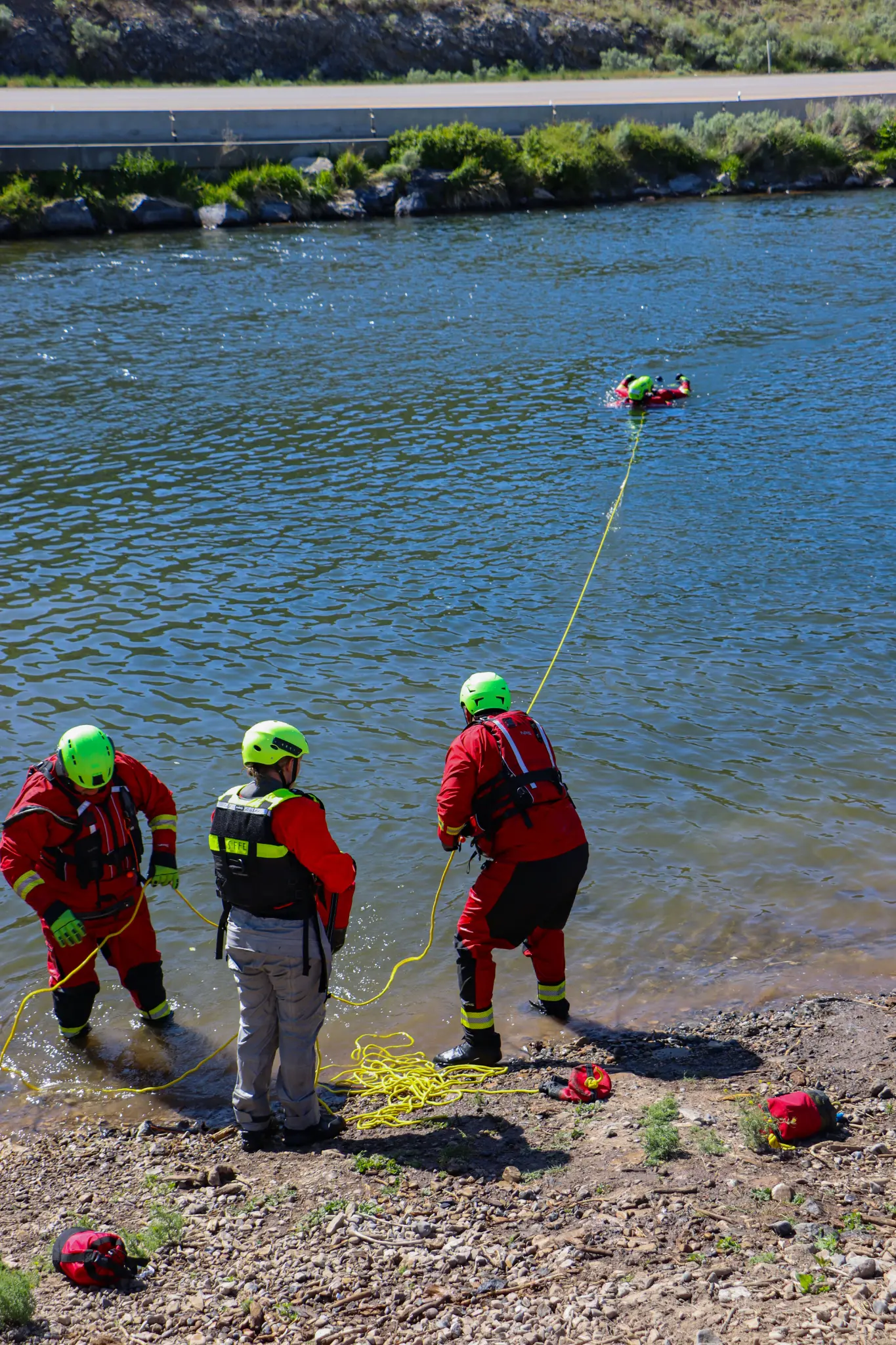 Surface water rescue - shore team managing tethered swimmer