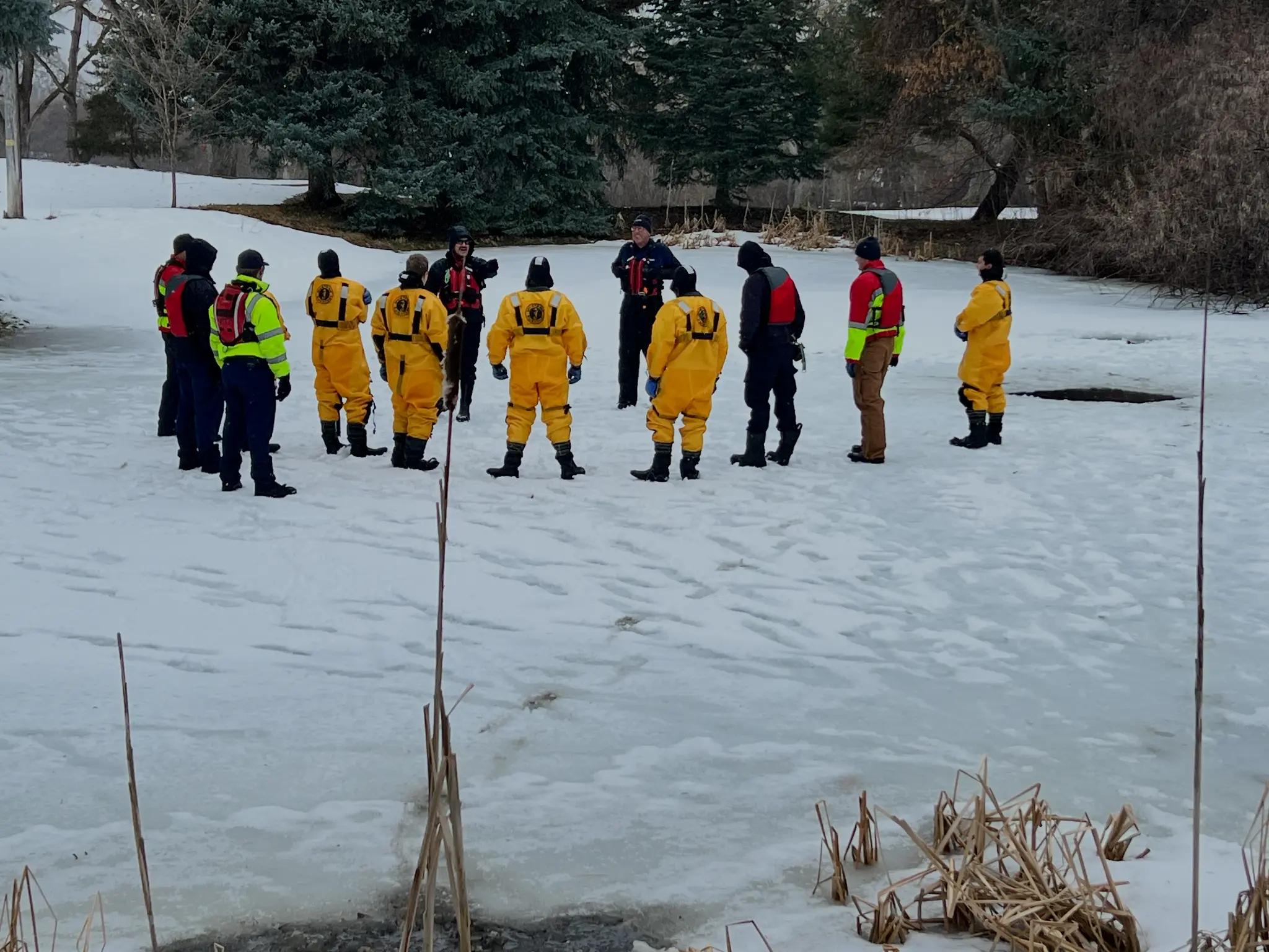 Ice rescue training - instructor briefing team on frozen pond